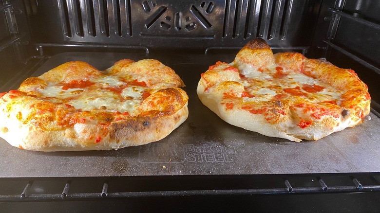 Two pizzas in oven on pizza steel