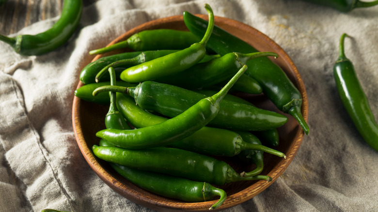 Green serranos in a wood bowl