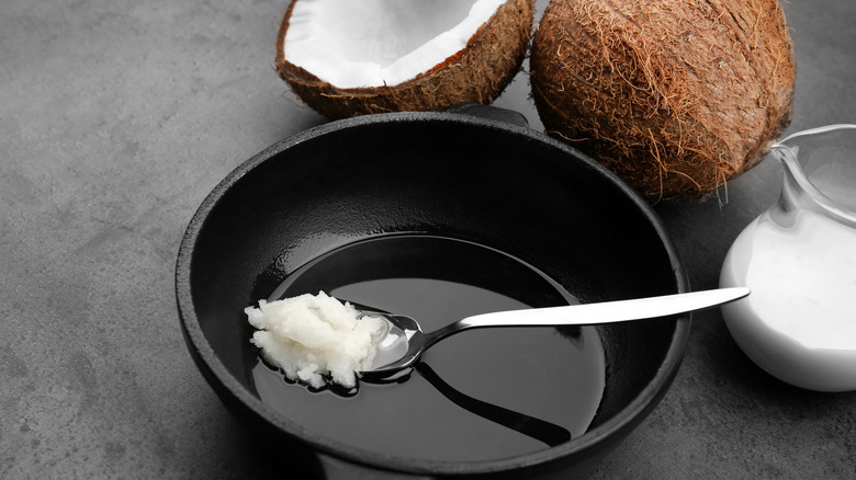 a spoon of coconut oil in a frying pan