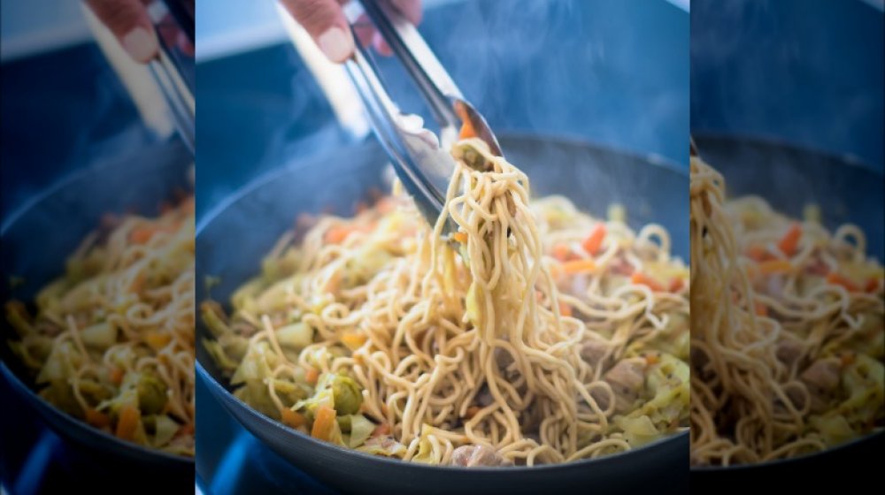 Cooking noodles in wok