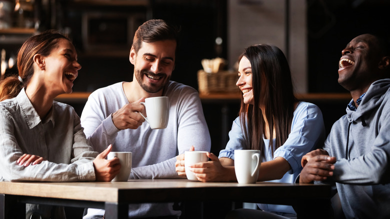 group friends drinking tea laughing