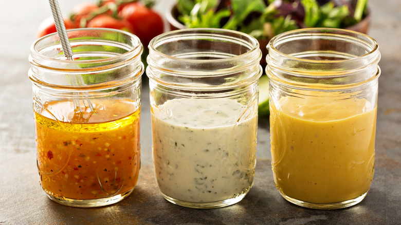 assortment of salad dressings in jars