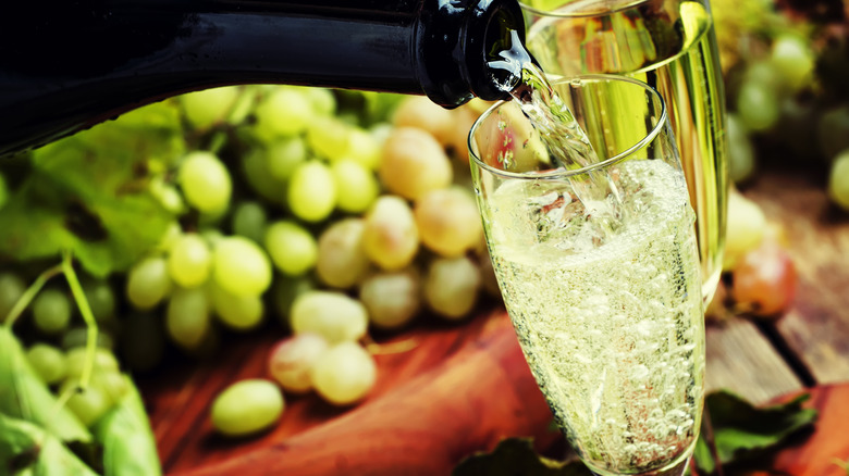 Bottle pouring champagne into a glass