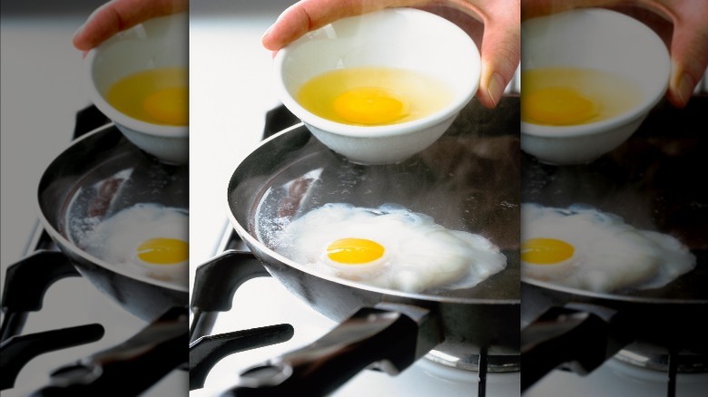 Pouring eggs into hot water