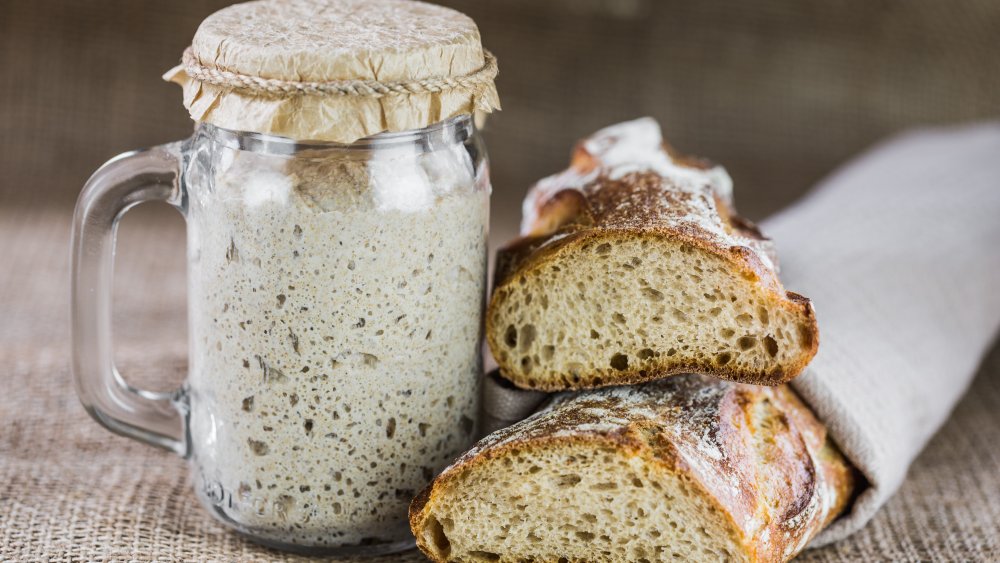 bread starter and loaf of bread