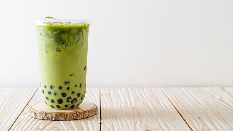 A matcha green bubble tea on a table