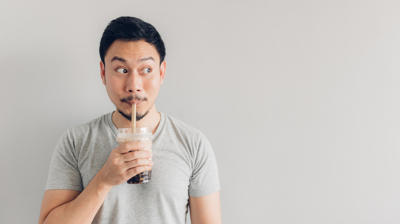 A man sipping on a bubble tea