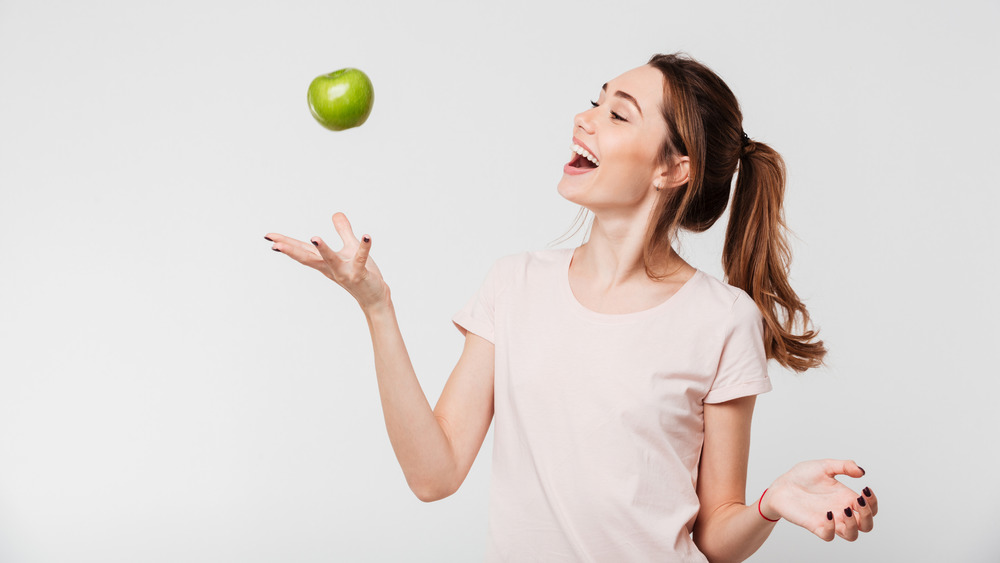 energetic woman with apple