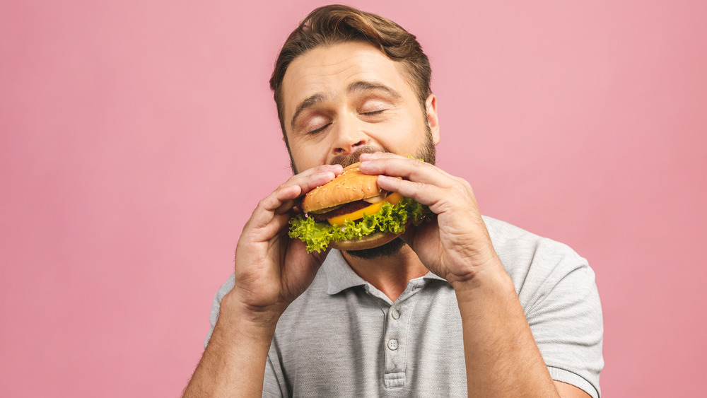 Man eating hamburger