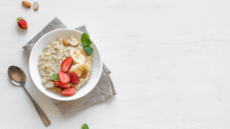 bowl of oatmeal topped with strawberries and bananas