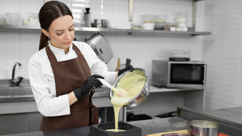 chef pouring batter into pan