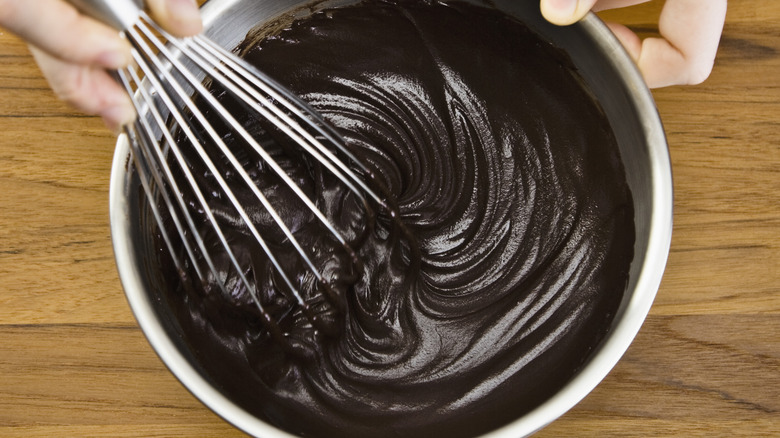 chocolate icing being whisked