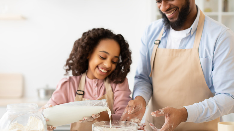 father and daughter making dough