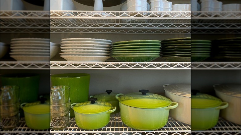 green Le Creuset bakeware and green and white plates in Ina Garten's kitchen