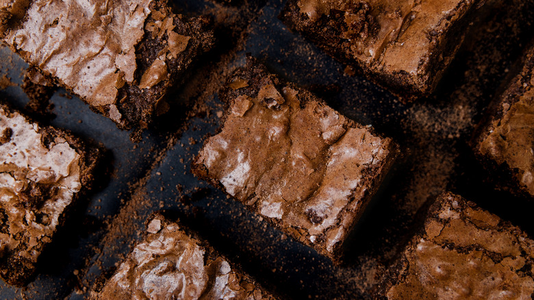 fudgy brownies against a dark backdrop