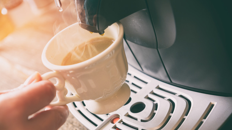 person making single coffee cup