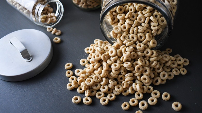 A jar of cheerios spilled on the table