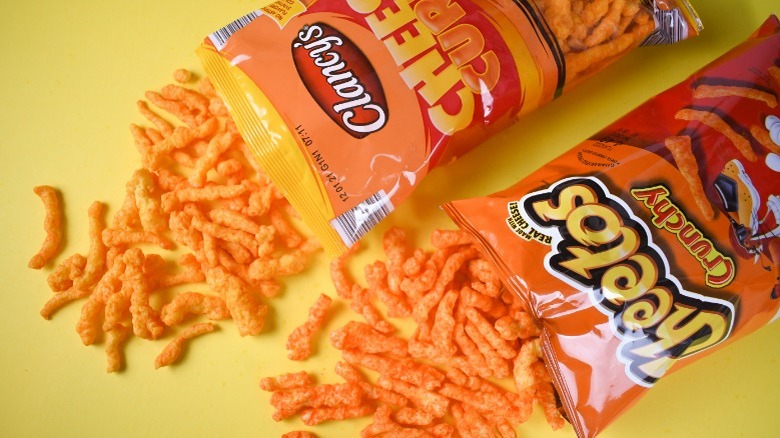 Bags of Cheetos and Aldi brand Clancy's Cheese Curls on a yellow background