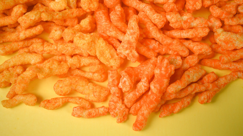 A plie of Cheetos Crunchy and Aldi brand Clancy's Cheese Curls