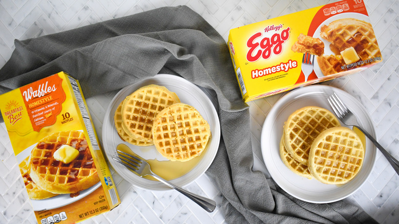 boxes of Eggo and ALDI brand frozen waffles with waffles on plates