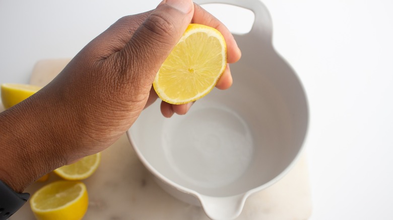 squeezing lemon juice into bowl