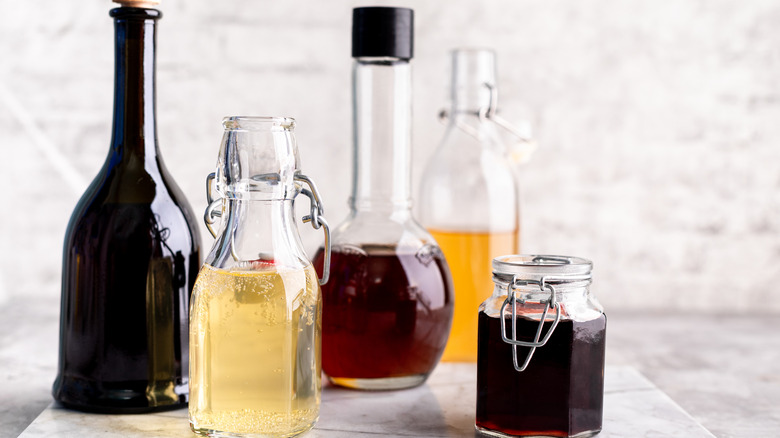 different vinegar types in glass bottles