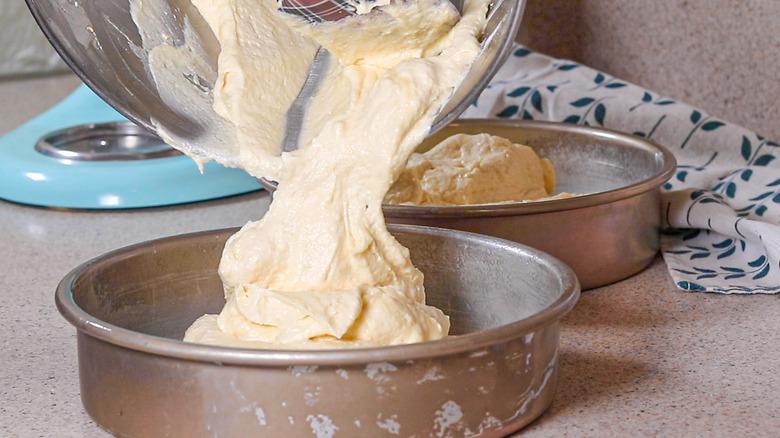 pouring cake batter in pan