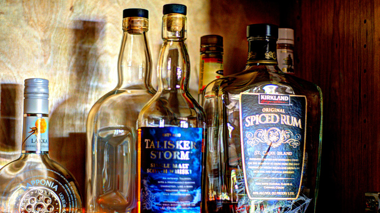 Kirkland rum among bottles in cabinet