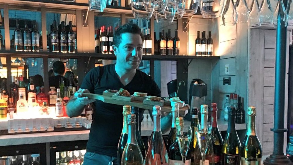 Gino D'Acampo behind wine bar