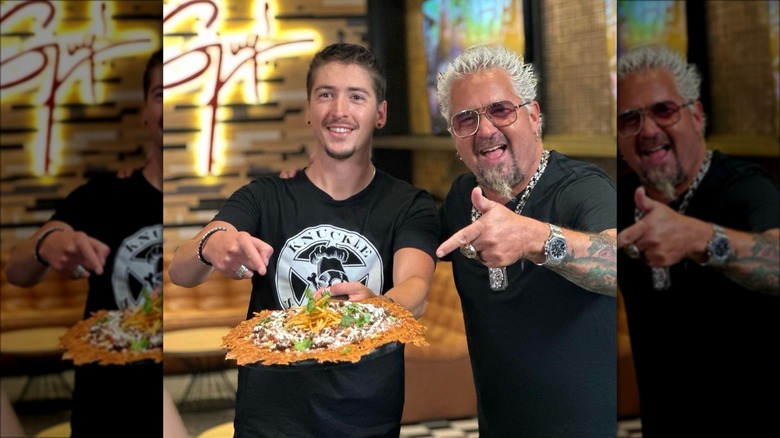 Hunter and Guy Fieri pointing at food