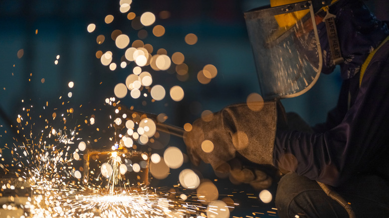 Welder at work with sparks flying