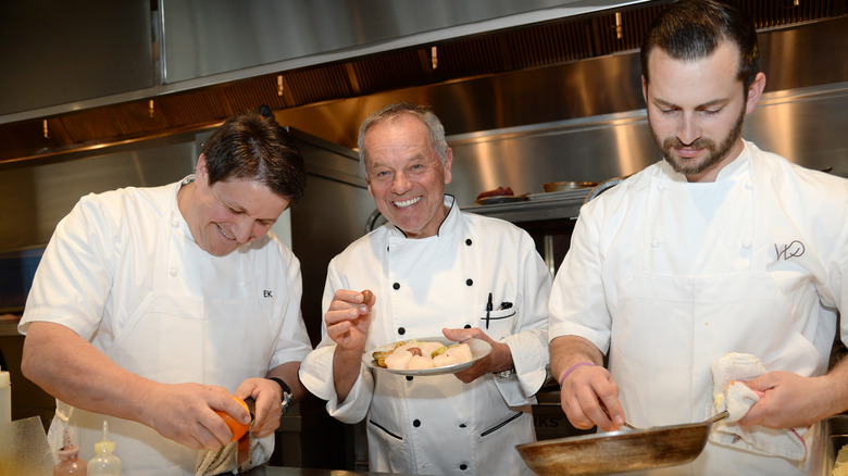 Wolfgang Puck and chefs in kitchen