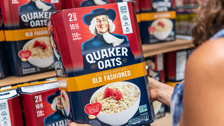 Person holding Quaker Oats box