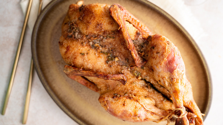 whole roasted duck on plate