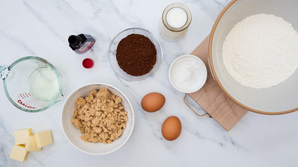 Marshmallow Fluff, sticks of butter, vanilla extract, eggs, buttermilk, oil, Dutch-process cocoa powder and flour on the counter