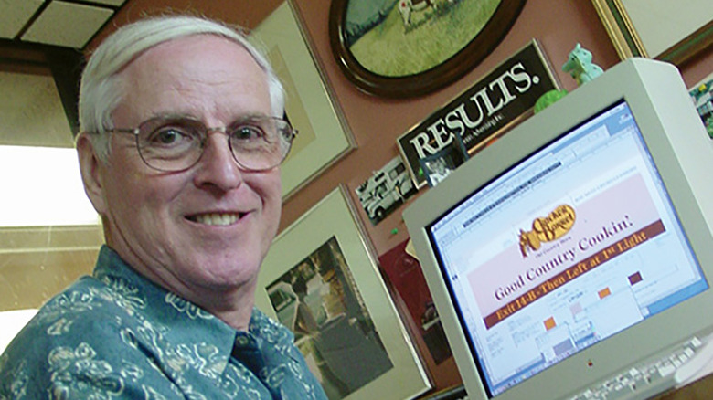 Bill Holley in front computer with Cracker Barrel logo