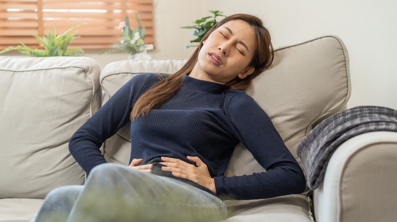 Woman holding stomach