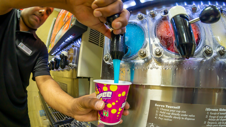 pouring a slurpee at a New York 7-Eleven store