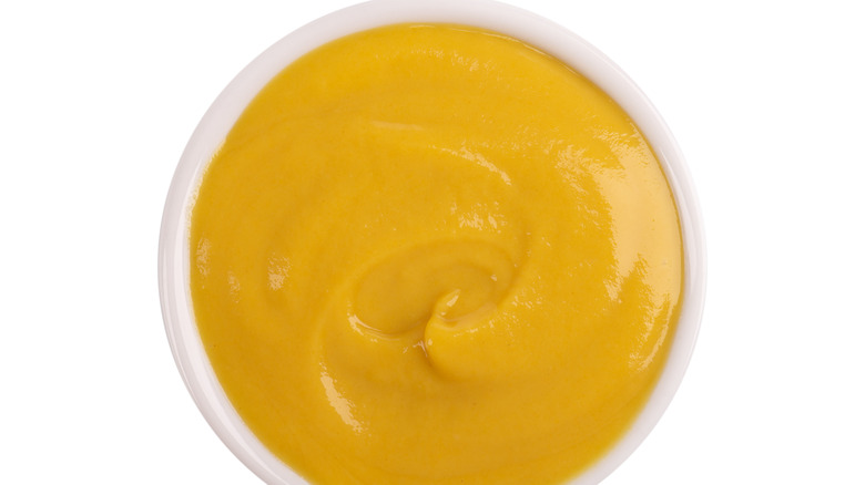 yellow mustard in a white bowl