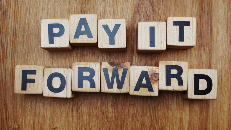 Pay it forward spelled out on letter blocks