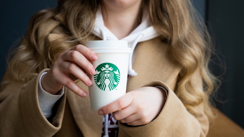 woman holding Starbucks cup