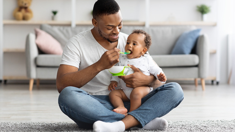 Father feeding infant son