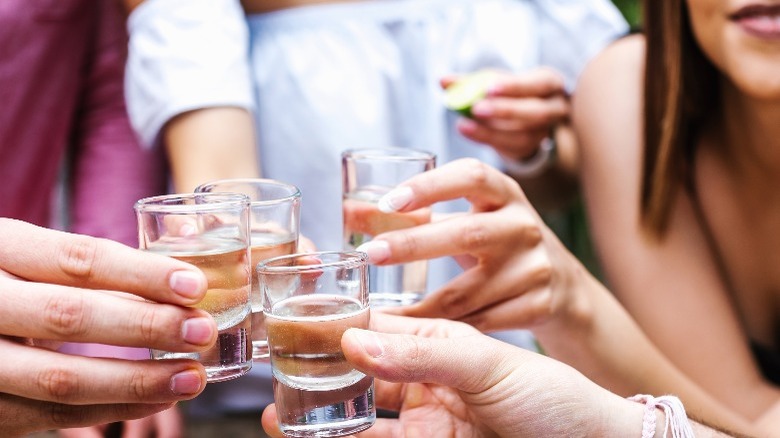 Group of people holding shots