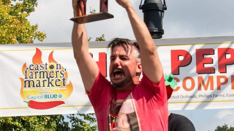 Kelly Joe Myers with the pepper-eating contest trophy