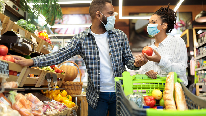 Shoppers wearing masks in grocery store