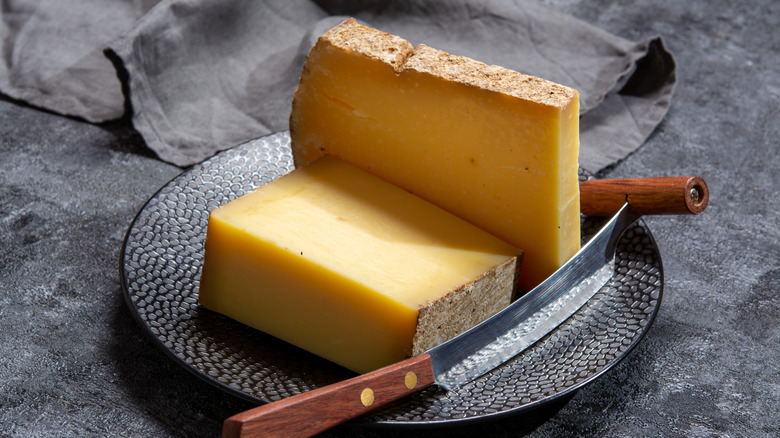 Gruyere cheese on a black plate