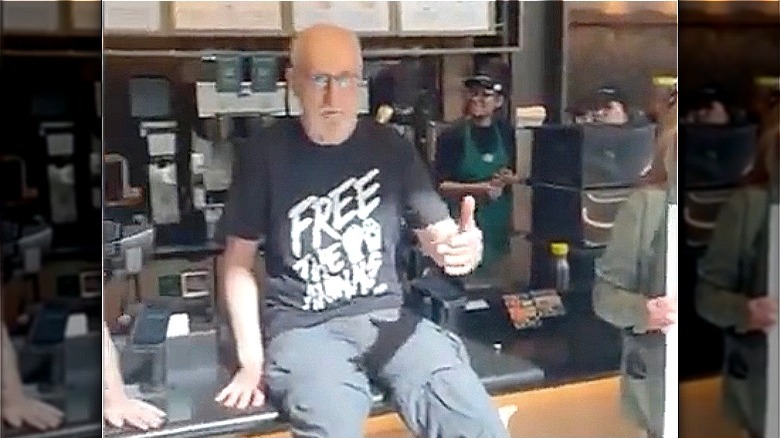 James Cromwell with his hand superglued to the Starbucks counter