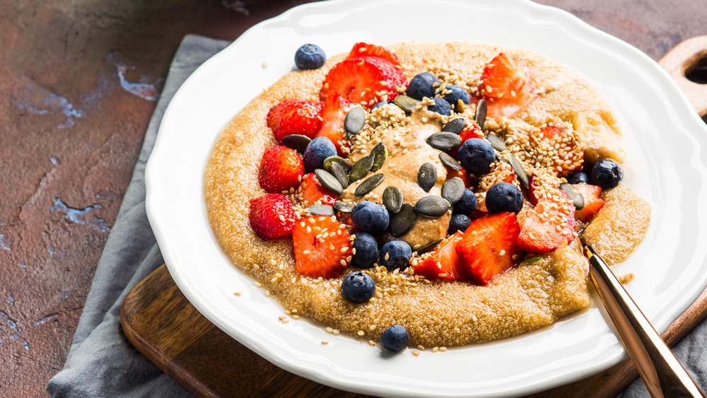 Amaranth porridge with fruit in a white bowl