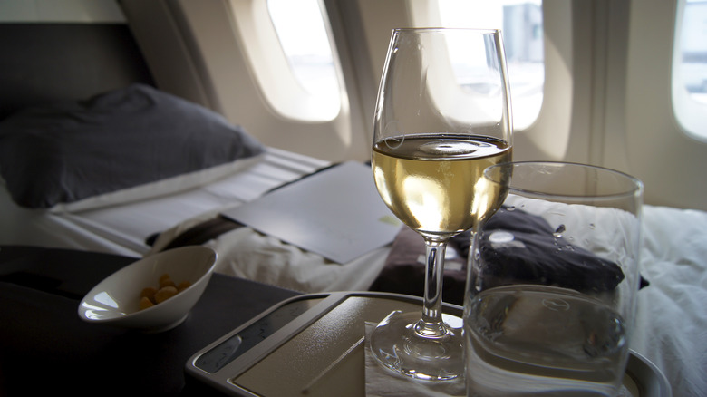 first class airline cabin wine service and lie-flat bed