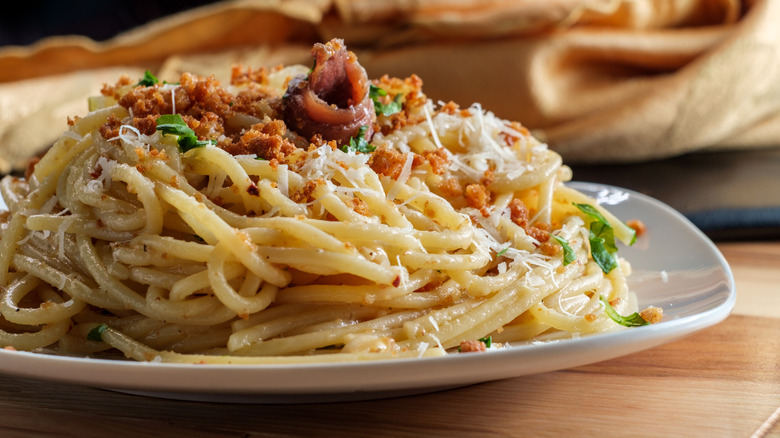 pasta dish with anchovies and bread crumbs on top